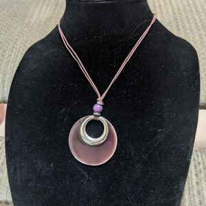 chunky statement necklace featuring a large circular pendant,